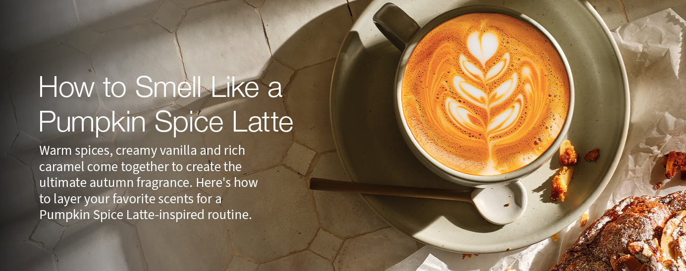 A pumpkin spice latte with latte art on a marble surface